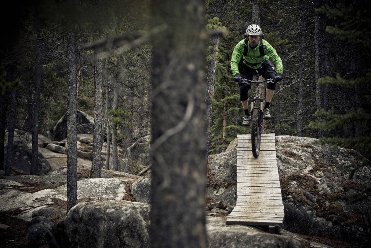 A male mountain biker rides the amazing trails of Carcross, Yukon during the fall colors.