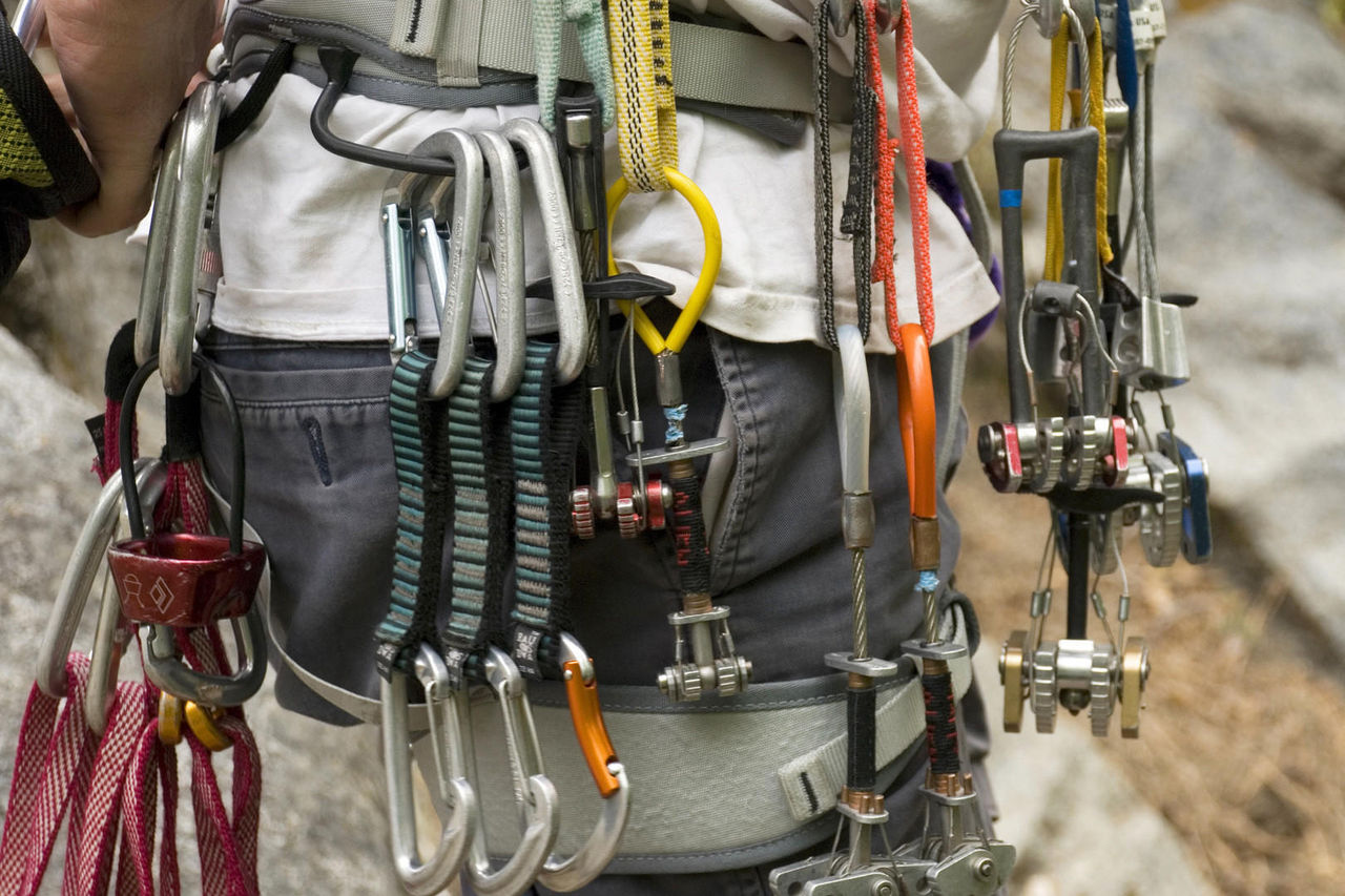 Collection of rock climbing gear attached to a climber's harness