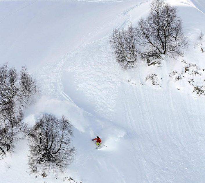 Skier in deep powder, extreme mountain freeride
